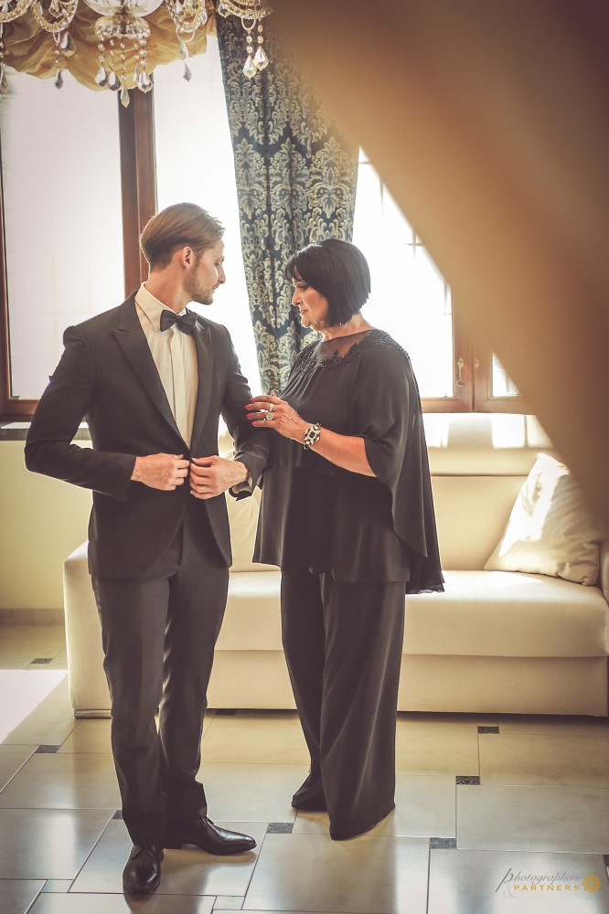 A final adjustment to the groom's suit.